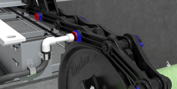 A close-up view of a Polychem drive chain assembly with SmartGuard technology in a wastewater treatment facility. The black chain with blue and red connectors is mounted on a gray metal frame. A white PVC pipe with a blue joint is visible, connected to the system.