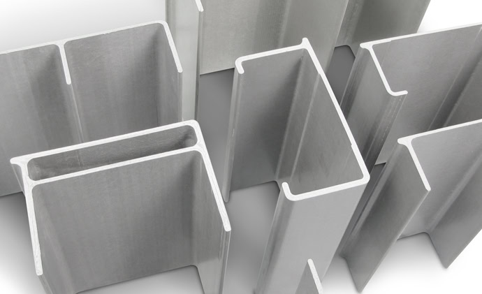 Close-up view of multiple metal channel sections, displayed in varying angles. The channels, likely made of steel or aluminum, exhibit smooth, reflective surfaces and sharp, clean edges