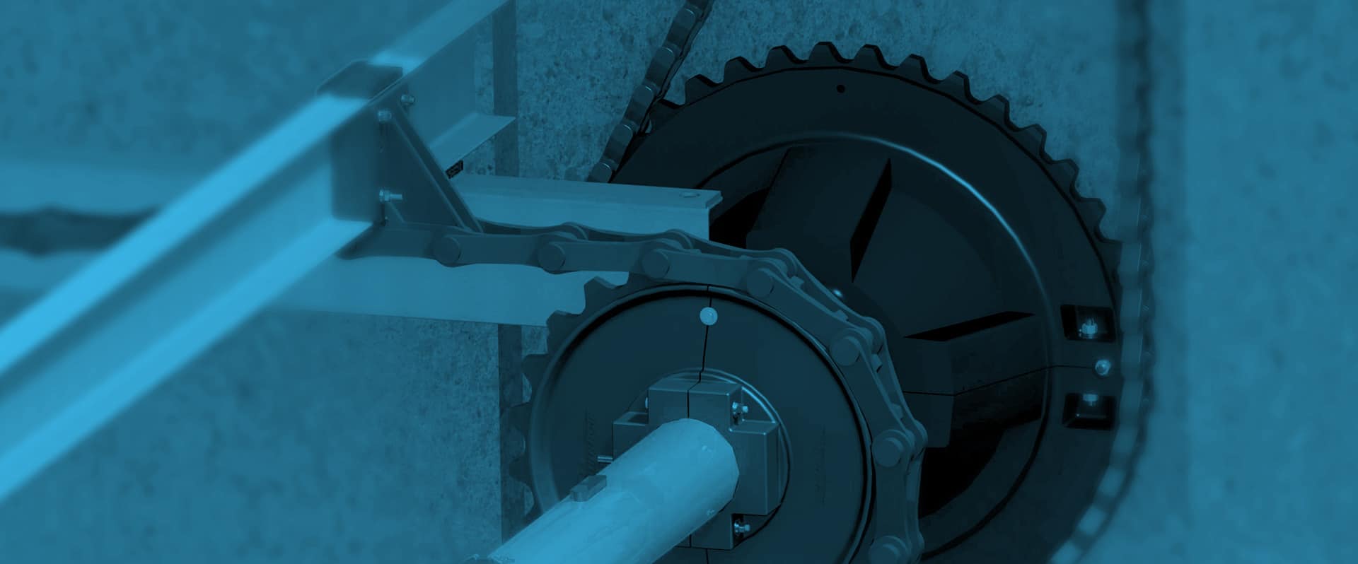 A close-up view of industrial machinery with cogwheels, head shafts, and a chain, all shown in a blue-tinted color scheme.