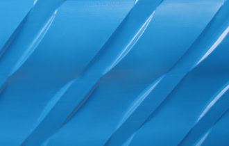 Close-up of a blue, textured surface with diagonal, wavy ridges running across it. The surface has a glossy finish, reminiscent of the sleek design found in the IFR-6000 Series,.