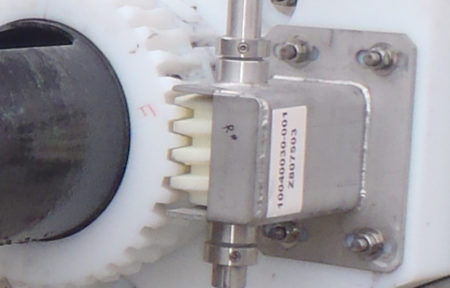 an image of a close up featuring the worm gear assembly belonging to a rotating trough