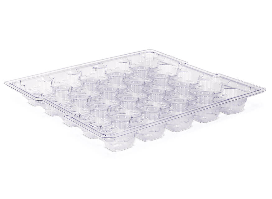 A clear plastic tray designed for packaging small items, featuring multiple evenly spaced, hexagon-shaped compartments. The tray has a flat rim around the edge for easy handling and is set against a white background.