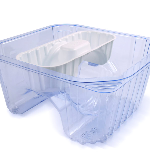 A mostly transparent plastic container with a white plastic inlay. The container is rectangular with rounded edges, and the white inlay forms a protruding structure in the middle.