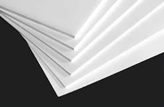 A close-up image of several overlapping, white rectangular sheets of paper fanned out against a dark background.