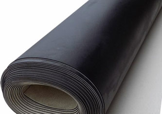 A close-up photo of a rolled-up sheet of black rubber matting. The mat is tightly coiled, showcasing its smooth surface and flexible material crafted from high-quality TPO.