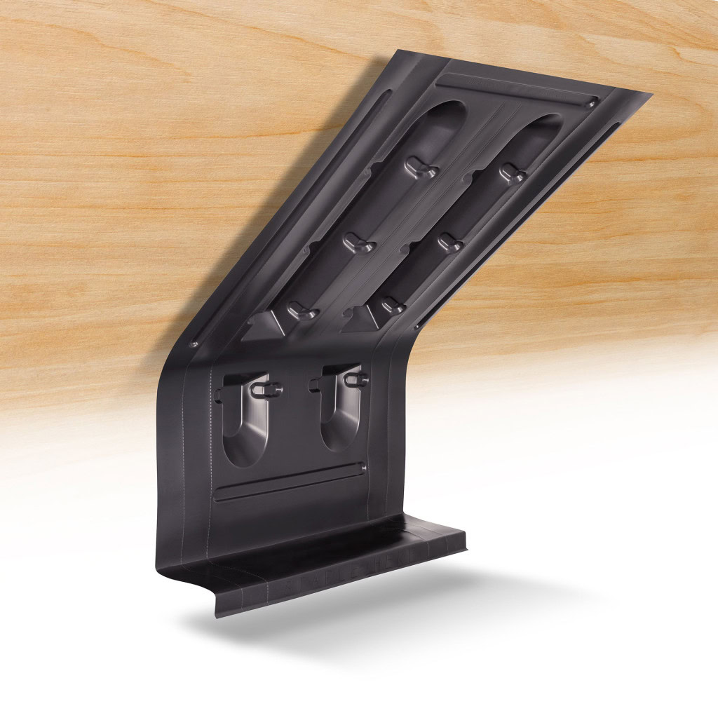 A sleek, black Accuvent product is mounted against a wood-paneled background.