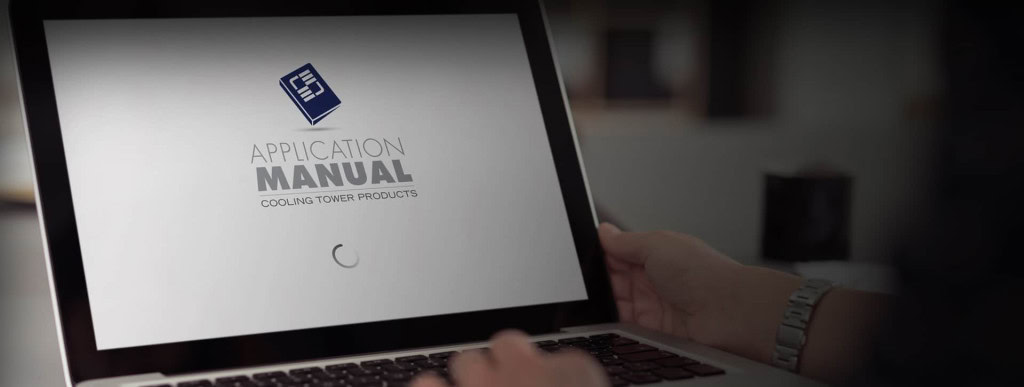 A person holding a laptop displaying a digital document from Brentwood Industries titled "Application Manual: Cooling Tower Products." The screen shows a loading icon below the title.