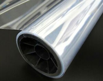 A close-up image of a roll of clear and shiny film, partially unrolled to the left.