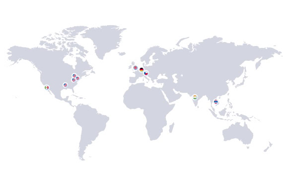 A world map with gray continents and oceans. Small icons with various national flags are placed in specific locations, showcasing Brentwood Industries locations.