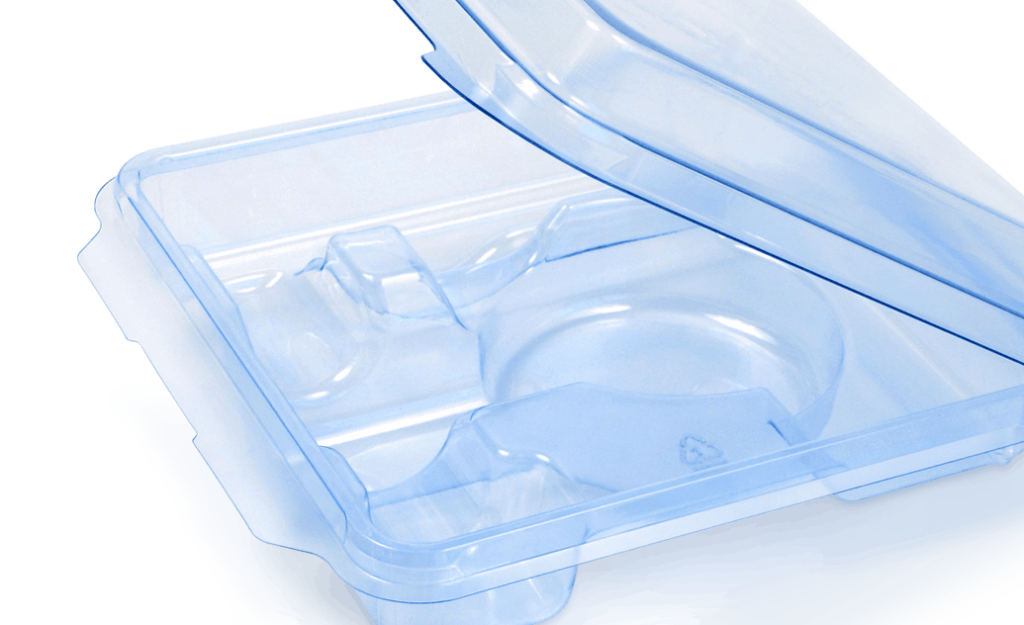 A photo of an open, transparent, blue plastic clamshell medical packaging container. The lid is partially open, revealing individual compartments inside.